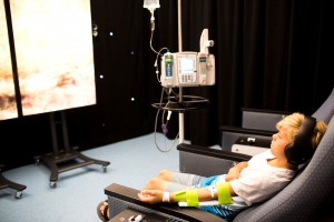 boy watching movie with an IV at the CHOC Infsuionarium